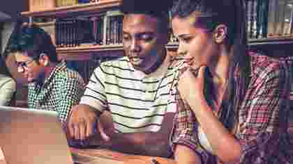 Adult Online Students Collaborating with Laptop